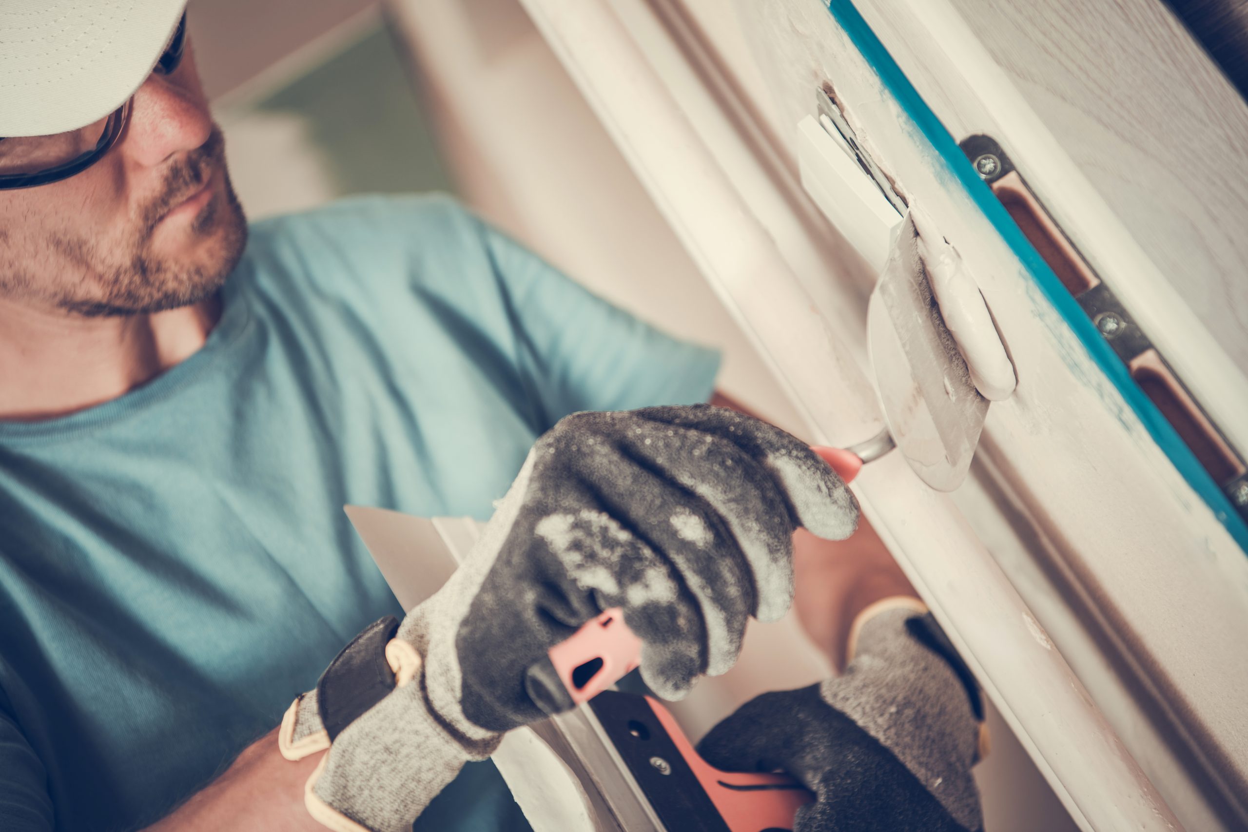 Skilled Worker Applying Plaster to Wall in a Home Renovation Project